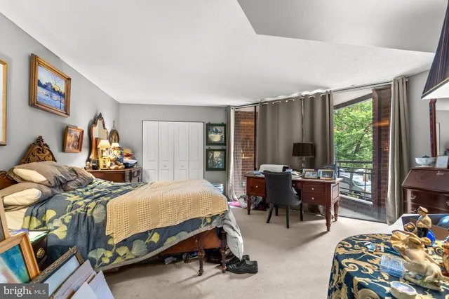 a bedroom with two beds and a large window