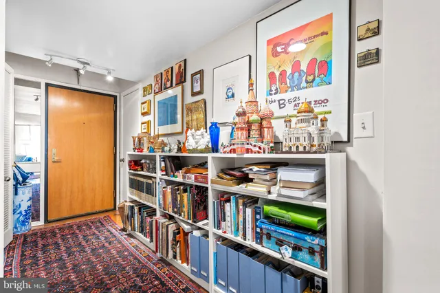 a room with lots of books and a large mirror