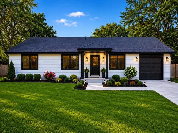 a front view of a house with a yard fire pit and outdoor seating