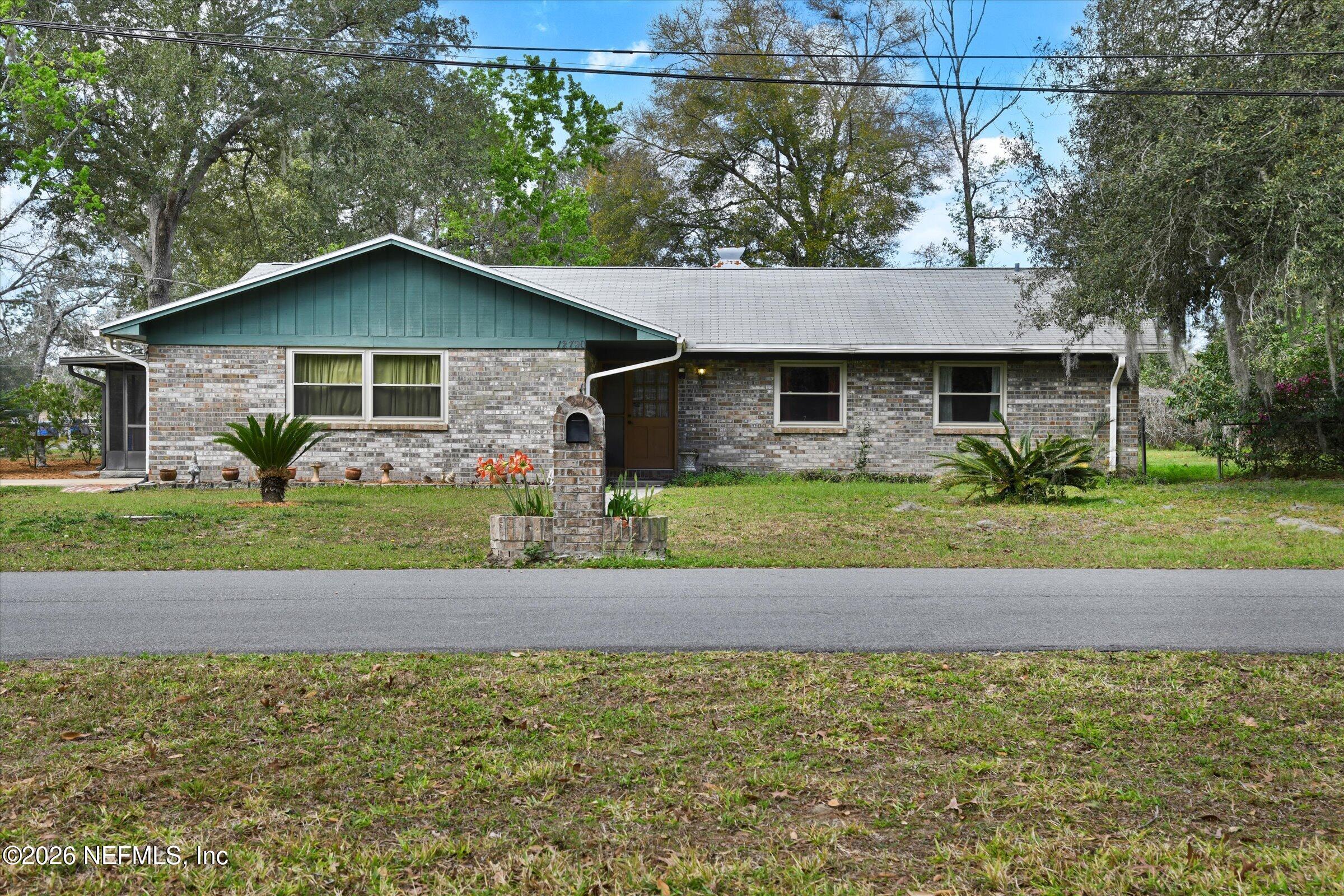 12790 Allport Road Jacksonville, FL 32258 - Photo 1 of 39 a front view of a house with a yard and garage