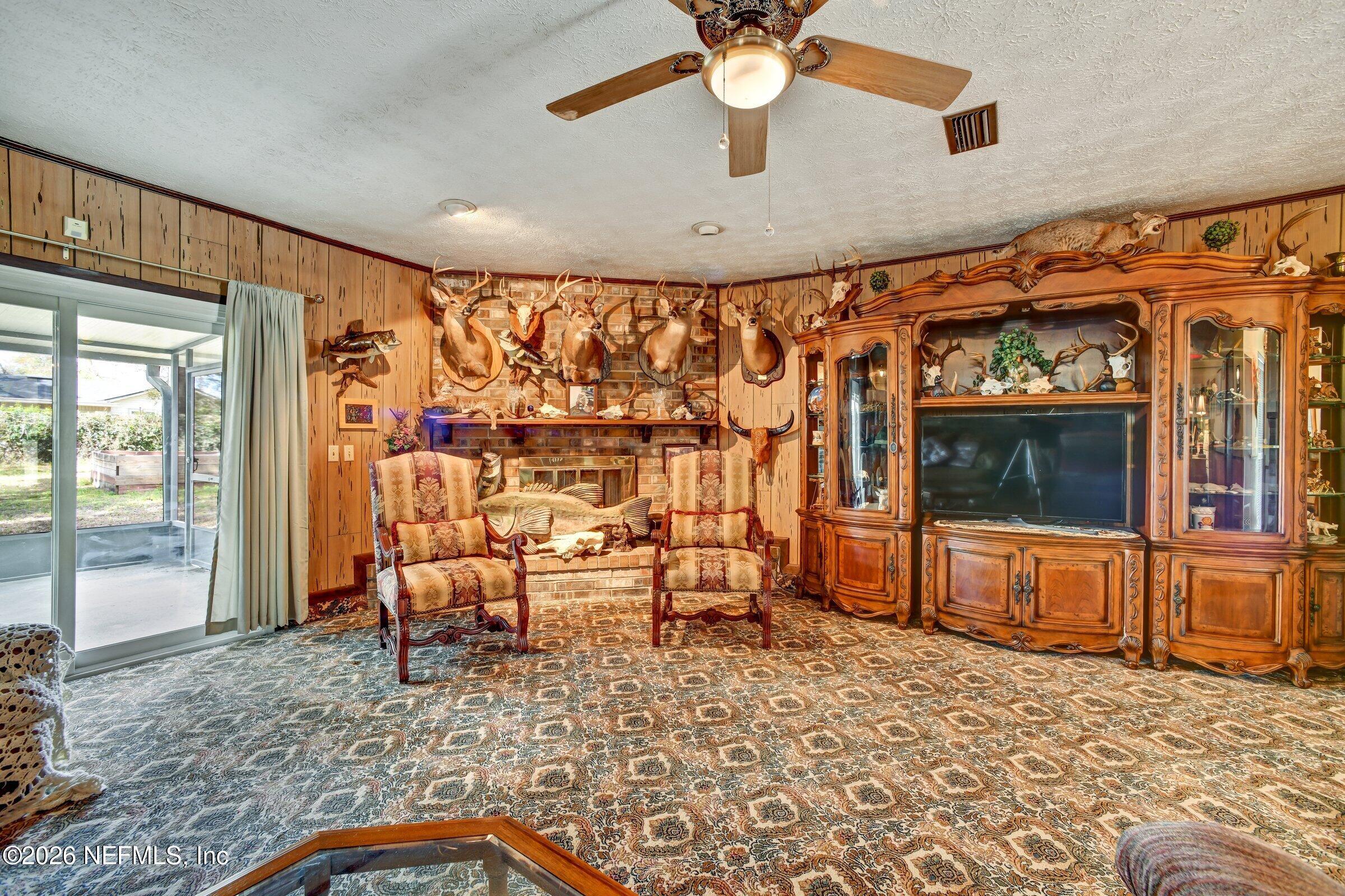 12790 Allport Road Jacksonville, FL 32258 - Photo 19 of 39 a living room with a couch and a flat screen tv