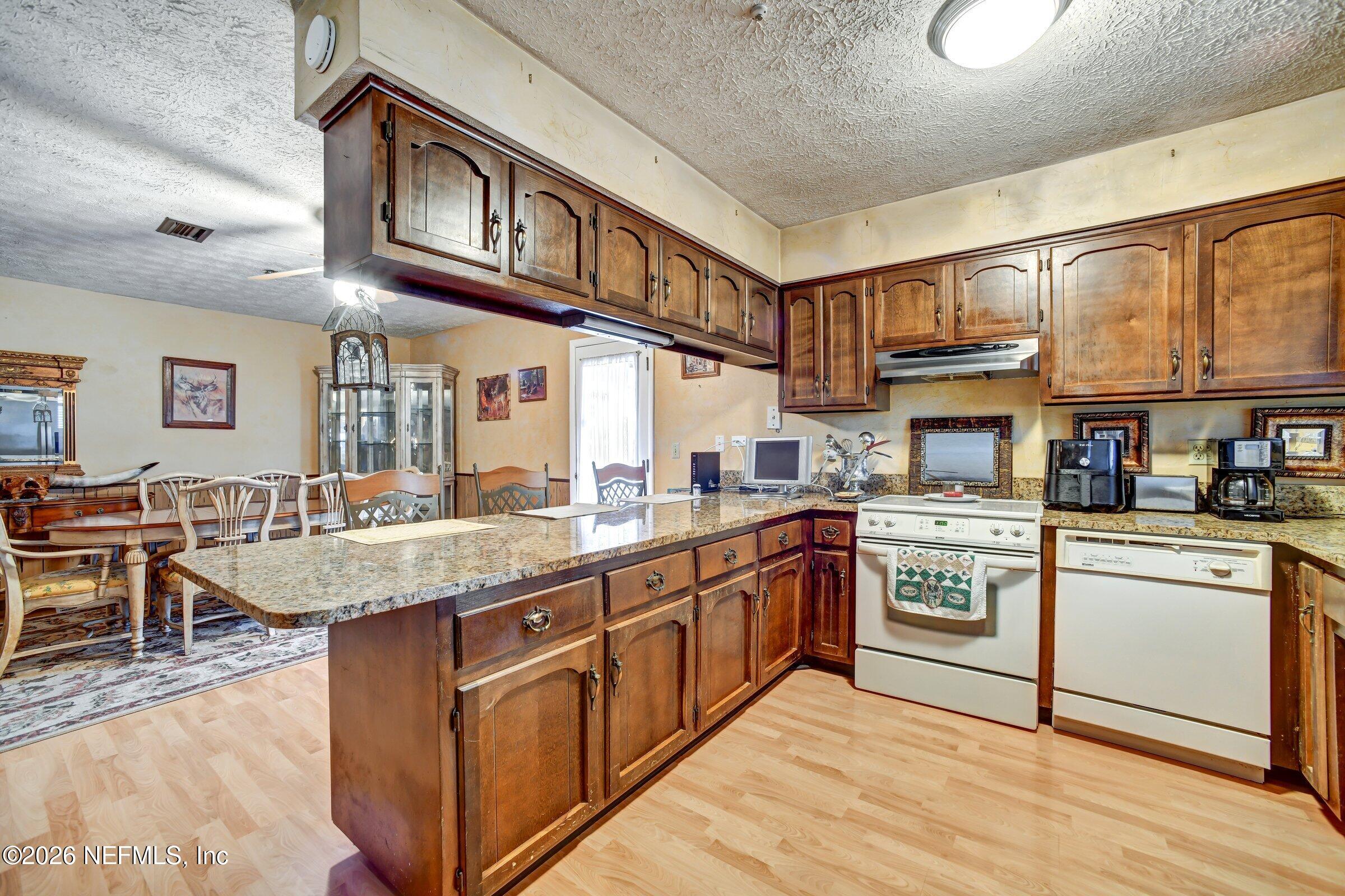 12790 Allport Road Jacksonville, FL 32258 - Photo 22 of 39 a kitchen with stainless steel appliances granite countertop a stove and cabinets