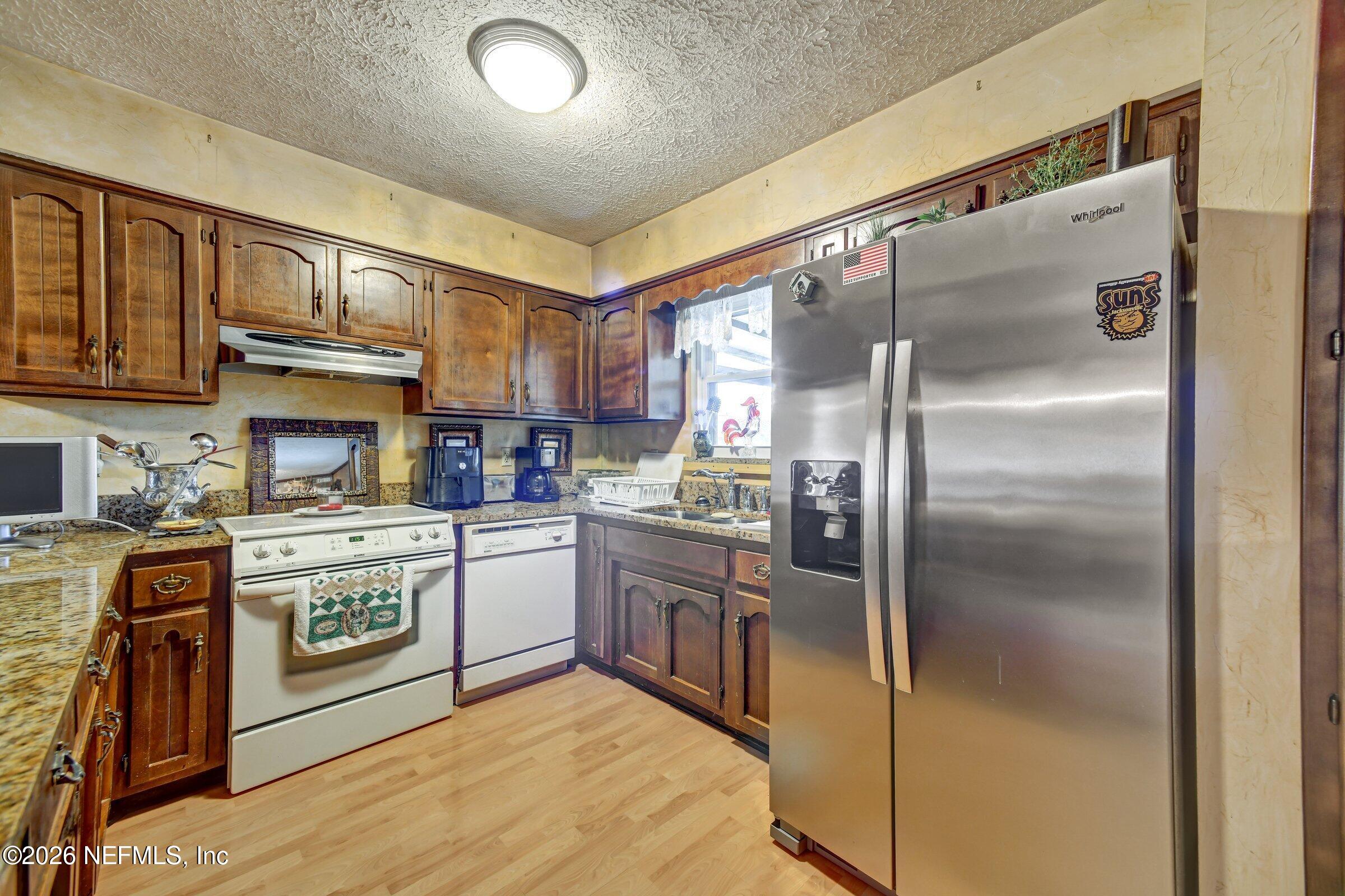 12790 Allport Road Jacksonville, FL 32258 - Photo 23 of 39 a kitchen with stainless steel appliances granite countertop a refrigerator a stove and a sink