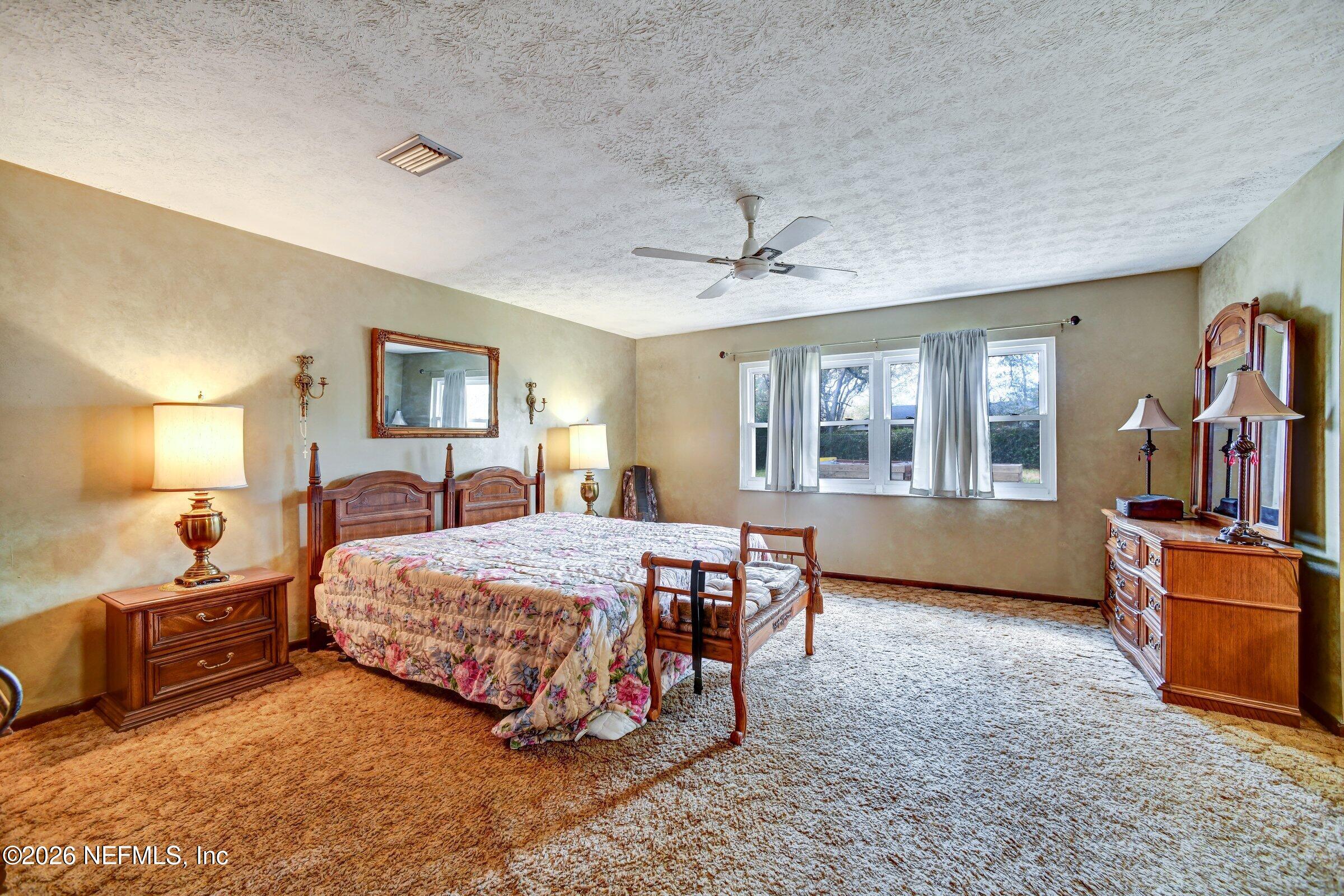 12790 Allport Road Jacksonville, FL 32258 - Photo 31 of 39 a bedroom with a bed and wooden floor