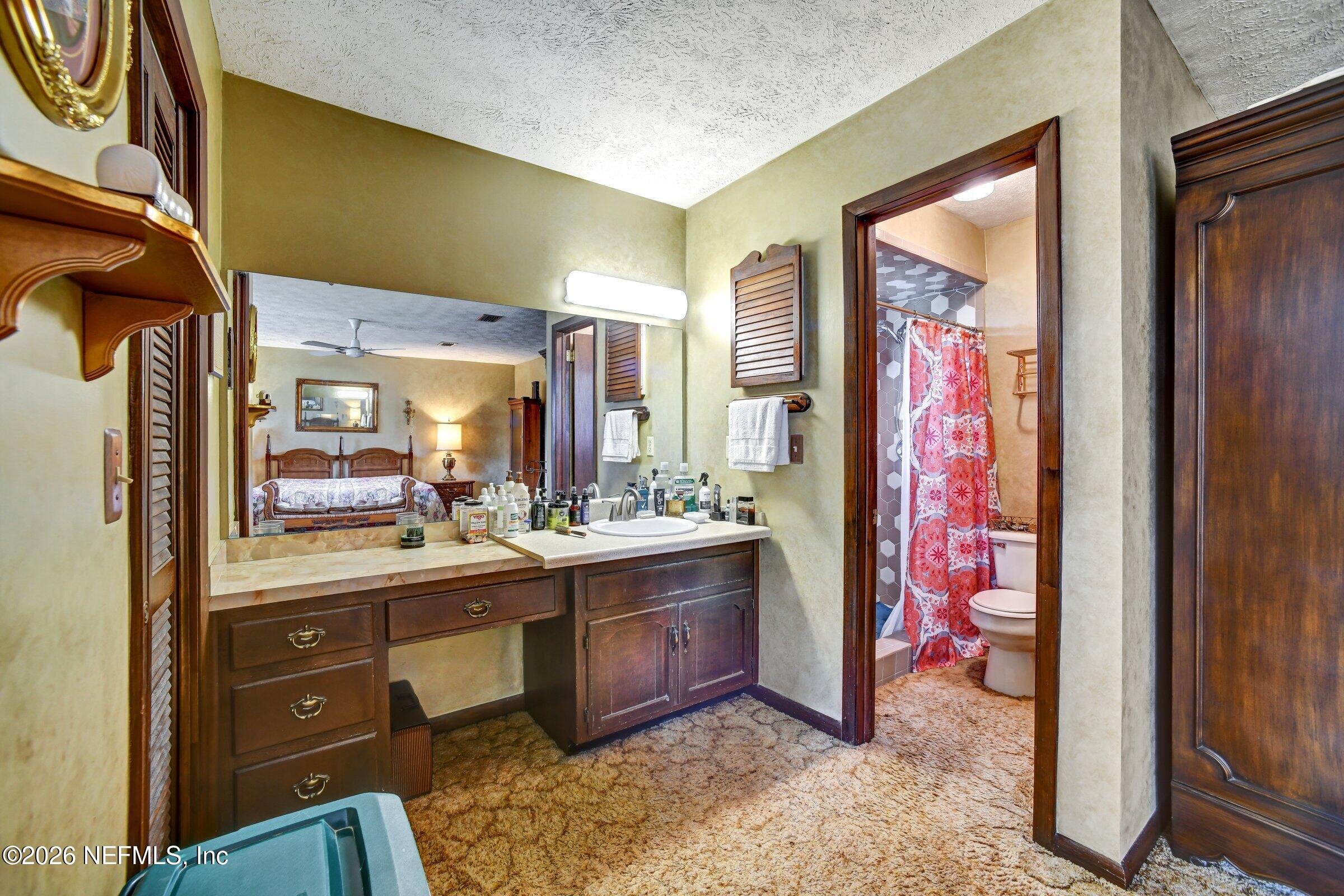 12790 Allport Road Jacksonville, FL 32258 - Photo 34 of 39 a bathroom with a sink a vanity and a mirror