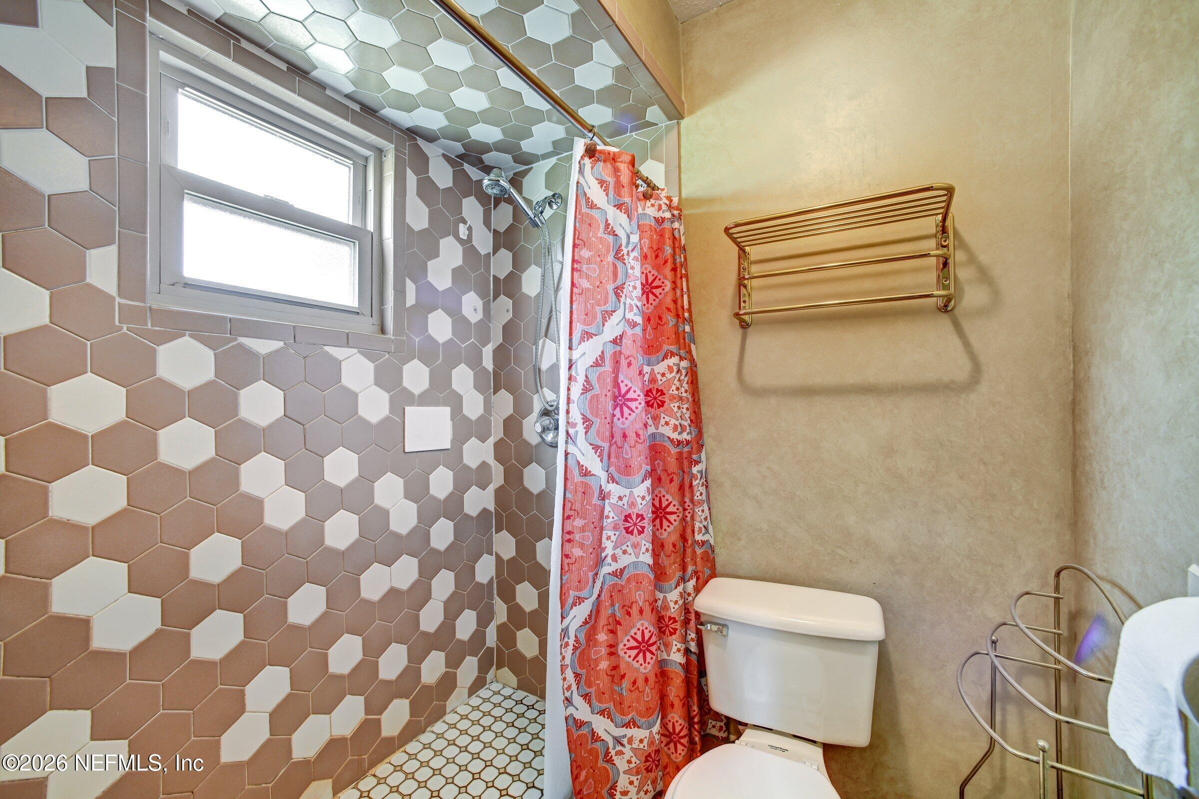 12790 Allport Road Jacksonville, FL 32258 - Photo 35 of 39 a bathroom with a toilet and a shower curtain