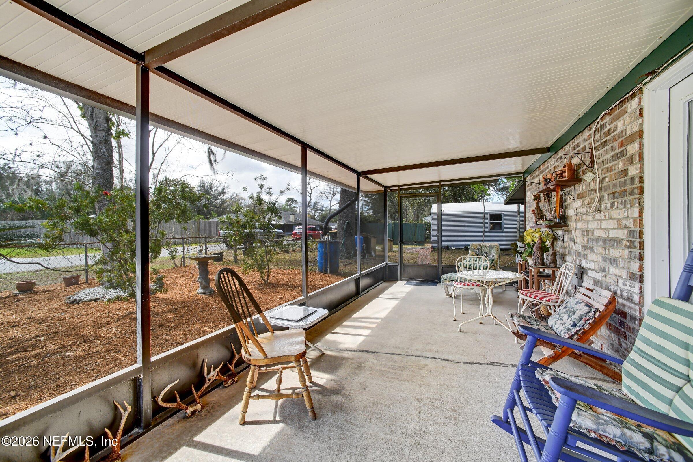 12790 Allport Road Jacksonville, FL 32258 - Photo 36 of 39 a view of a chair and tables in the balcony