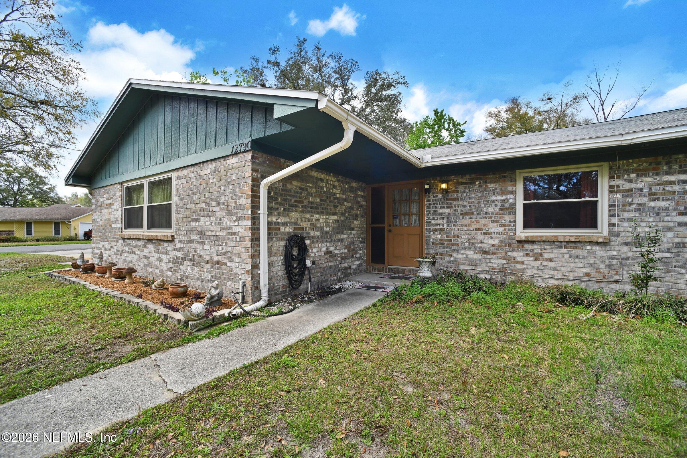 12790 Allport Road Jacksonville, FL 32258 - Photo 4 of 39 a front view of a house with a garden