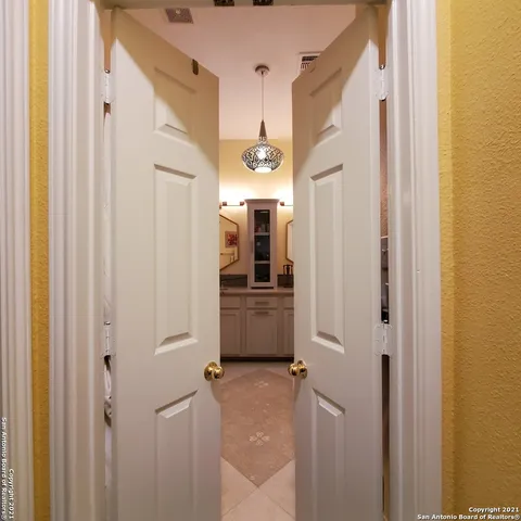 a view of a hallway with wooden shelves