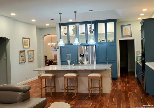 a kitchen with a table chairs refrigerator and microwave