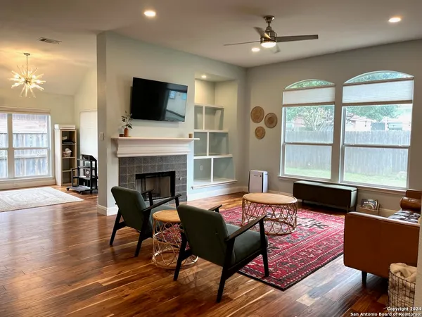 a living room with furniture fireplace and flat screen tv