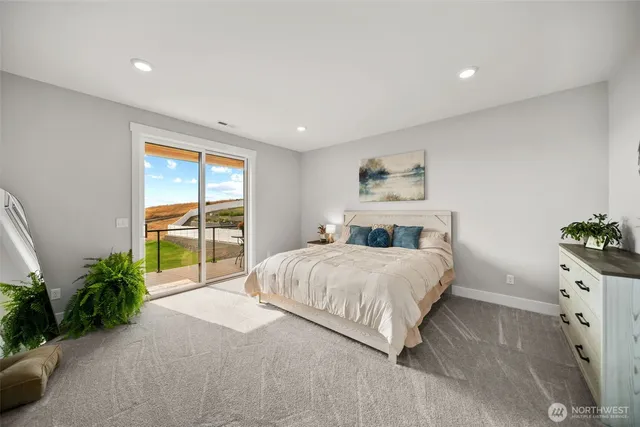 a spacious bedroom with a large bed and a potted plant