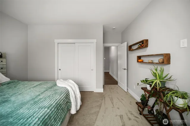 a bedroom with a bed and a potted plant