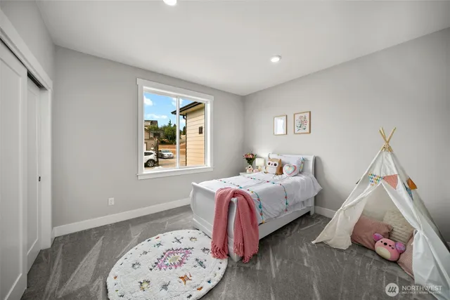 a bedroom with bed and a window