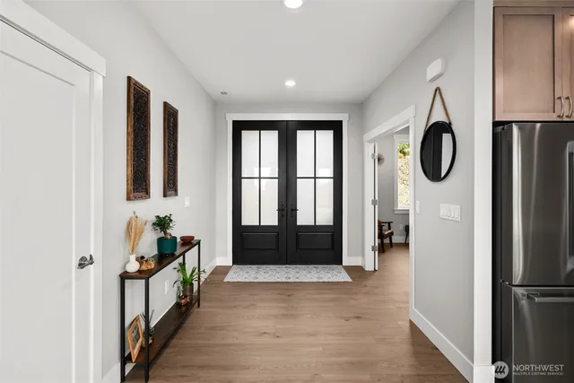 a view of an entryway with wooden floor