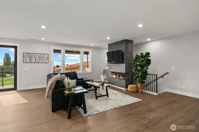 a living room with furniture flowers and a potted plant