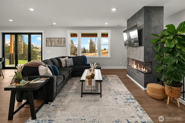 a living room with furniture and a potted plant