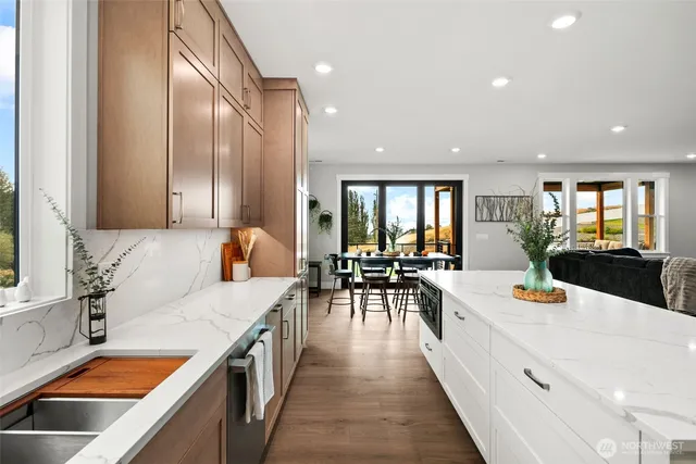 a large white kitchen with lots of counter space and living room