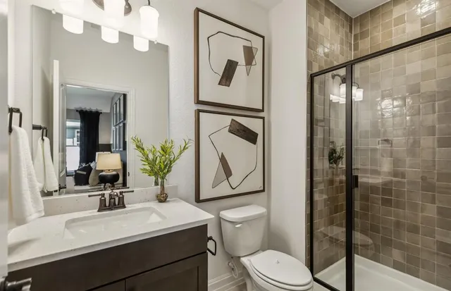 a bathroom with a double vanity sink a large mirror a bathtub and shower