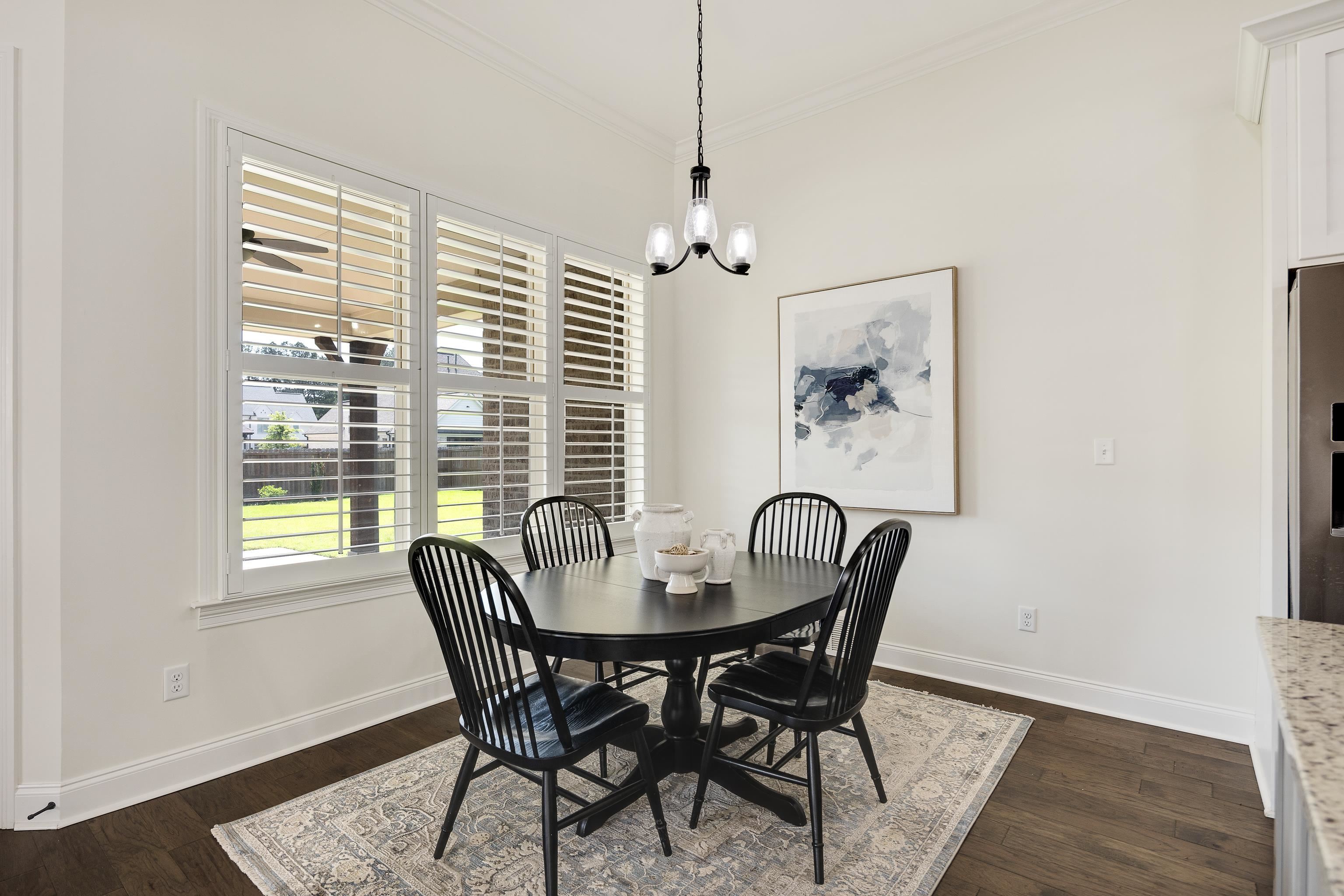 4728 Carousel Lane Collierville, TN 38017 - Photo 13 of 40 Dining space featuring crown molding, baseboards, dark wood finished floors, and a chandelier
