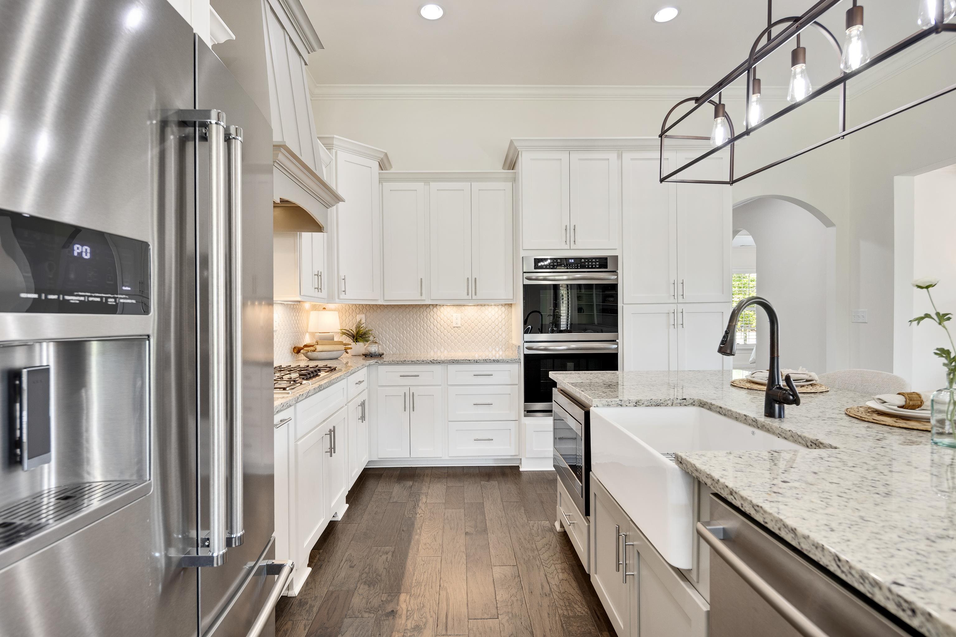 4728 Carousel Lane Collierville, TN 38017 - Photo 14 of 40 Kitchen featuring stainless steel appliances, arched walkways, a sink, recessed lighting, and crown molding