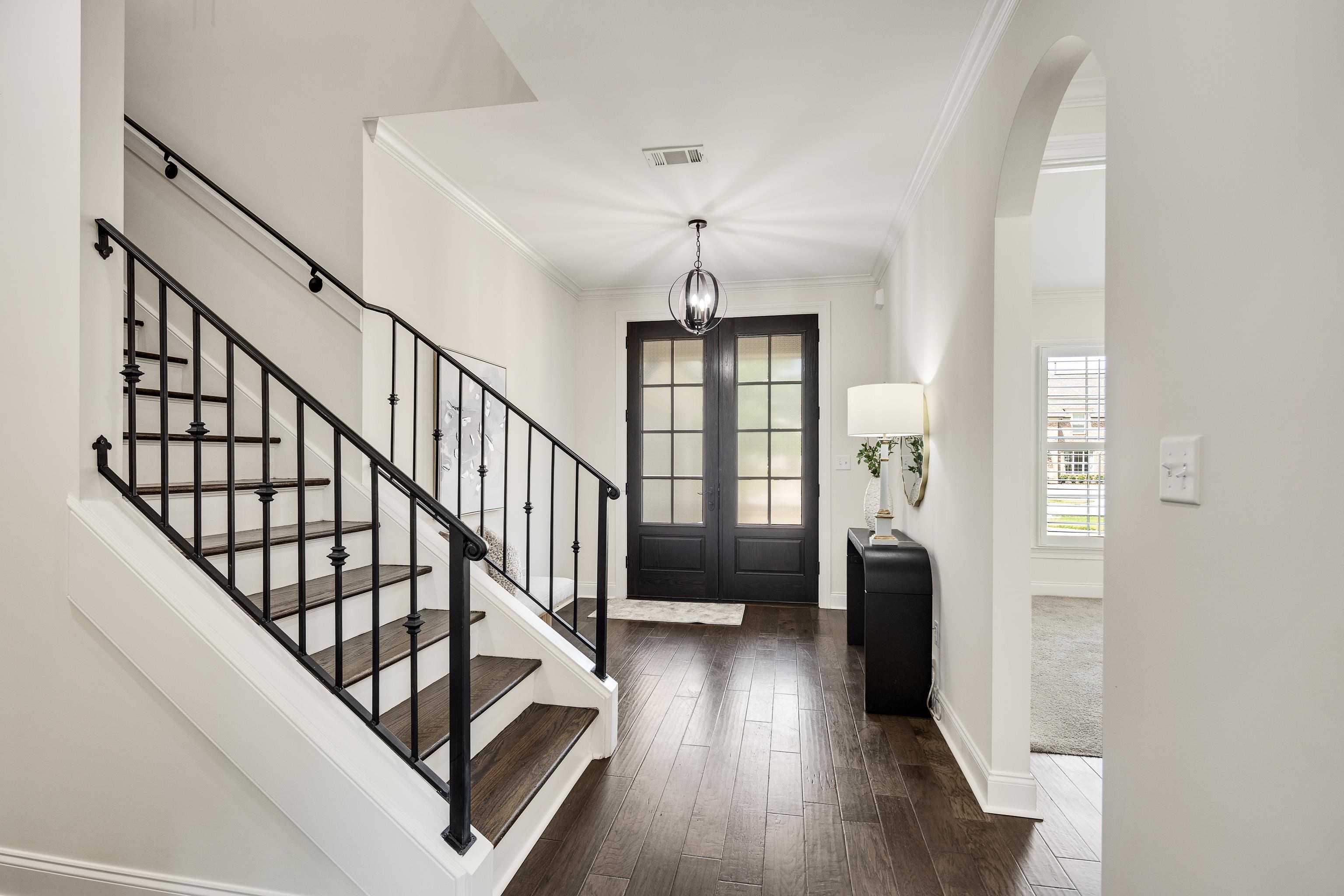 4728 Carousel Lane Collierville, TN 38017 - Photo 3 of 40 Entrance foyer featuring ornamental molding, stairs, dark wood finished floors, baseboards, and arched walkways