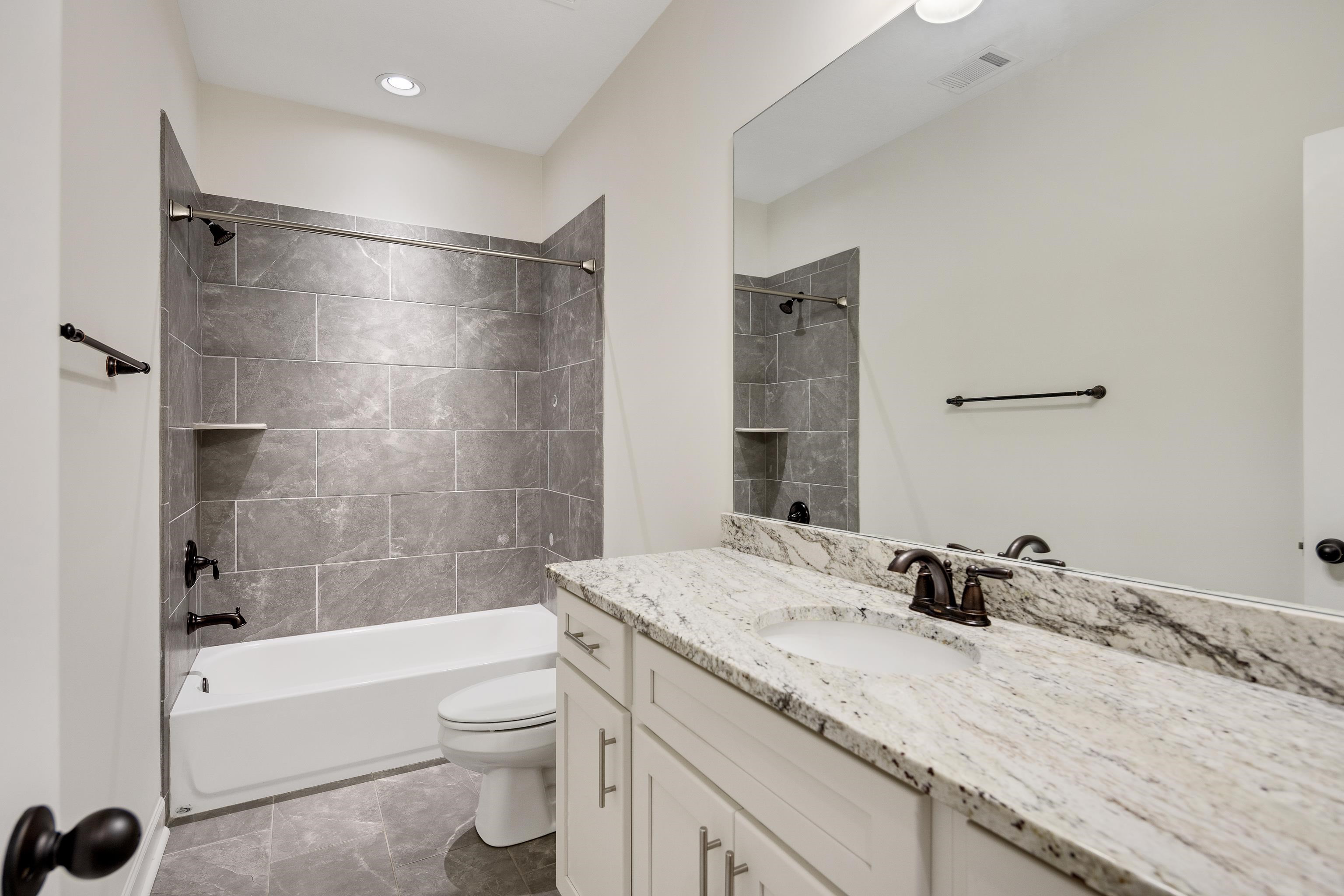 4728 Carousel Lane Collierville, TN 38017 - Photo 36 of 40 Bathroom featuring toilet, bathing tub / shower combination, and vanity