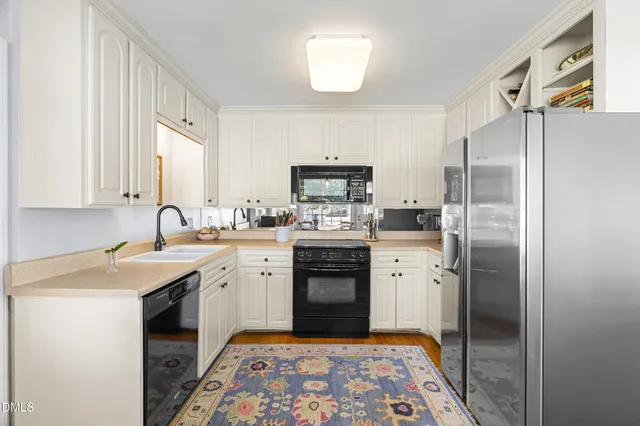 a kitchen with a sink stove and refrigerator