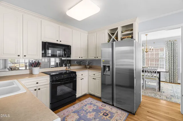 a kitchen with stainless steel appliances granite countertop a stove a refrigerator and a sink