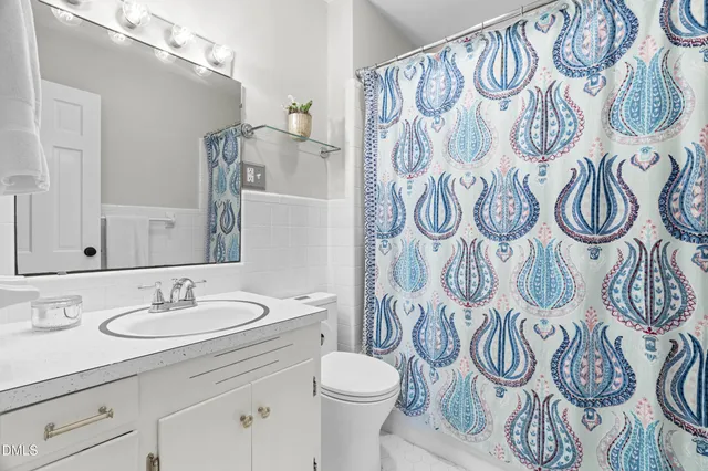 a bathroom with a sink and mirror with toilet