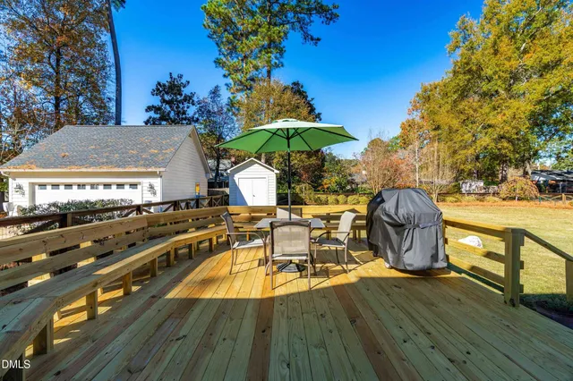 a view of a chairs and table on the wooden deck
