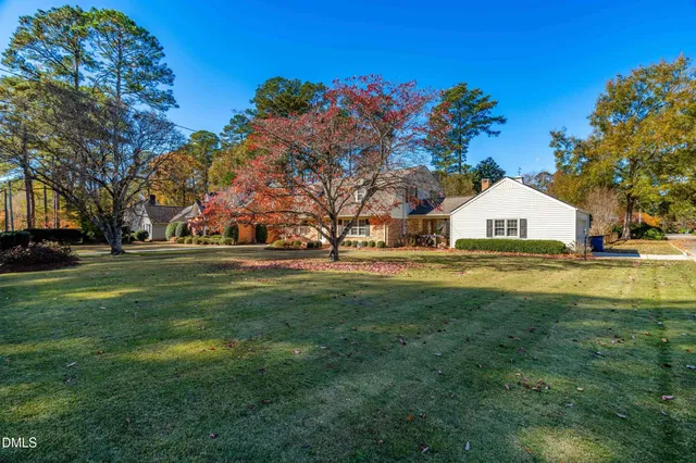 a view of white house with a yard