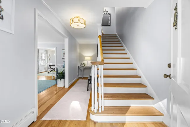 a view of entryway and hall with wooden floor