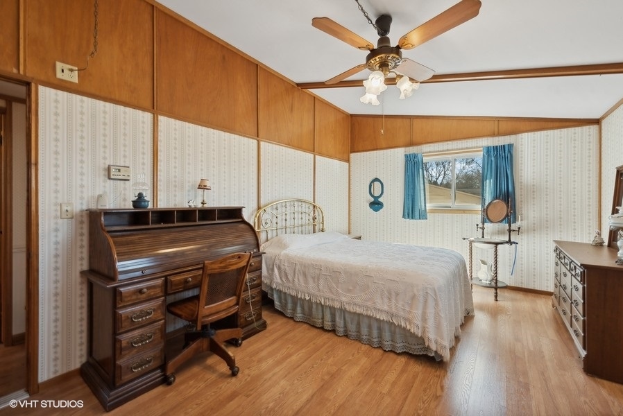 4605 South Ridgeway Road Ringwood, IL 60072 - Photo 11 of 25 a bedroom with a bed and a chandelier