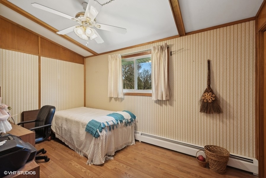 4605 South Ridgeway Road Ringwood, IL 60072 - Photo 12 of 25 a bedroom with a bed and a chandelier