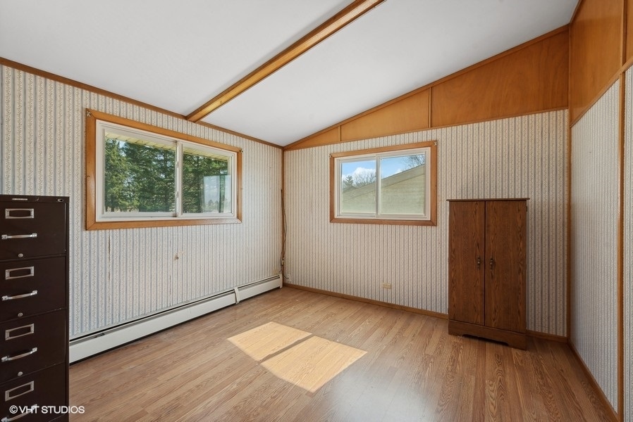 4605 South Ridgeway Road Ringwood, IL 60072 - Photo 13 of 25 a view of an empty room with wooden floor and a window