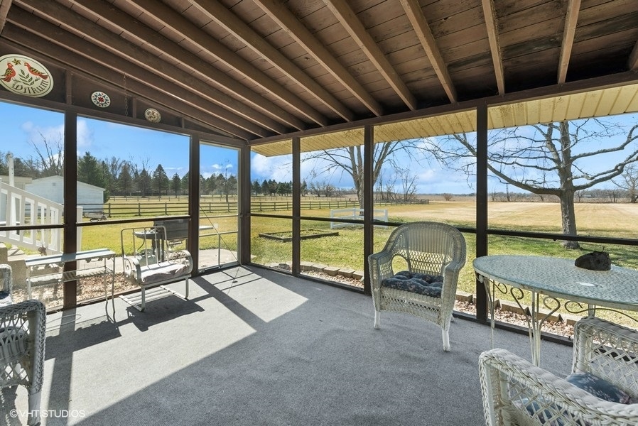4605 South Ridgeway Road Ringwood, IL 60072 - Photo 16 of 25 a living room with furniture and a floor to ceiling window