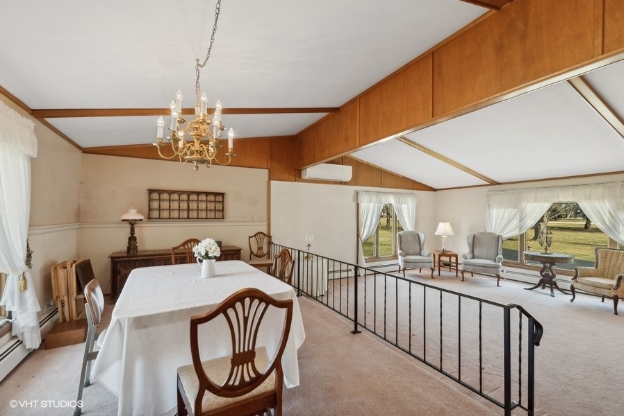 4605 South Ridgeway Road Ringwood, IL 60072 - Photo 5 of 25 a view of a dining room and livingroom with furniture wooden floor a chandelier