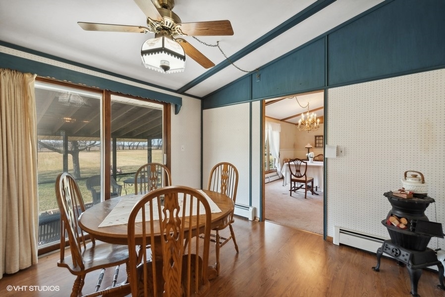 4605 South Ridgeway Road Ringwood, IL 60072 - Photo 7 of 25 a dining room with furniture a chandelier and wooden floor