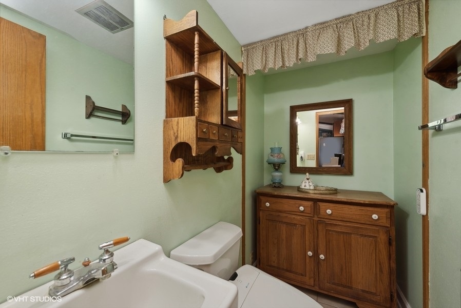 4605 South Ridgeway Road Ringwood, IL 60072 - Photo 9 of 25 a bathroom with a toilet sink and mirror