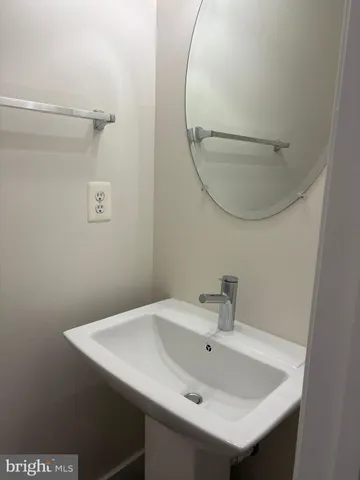 a bathroom with a sink a mirror and a vanity