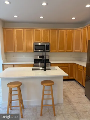 a kitchen with a stove a sink and a refrigerator