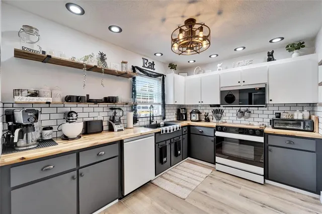 a kitchen with stainless steel appliances granite countertop a sink and cabinets