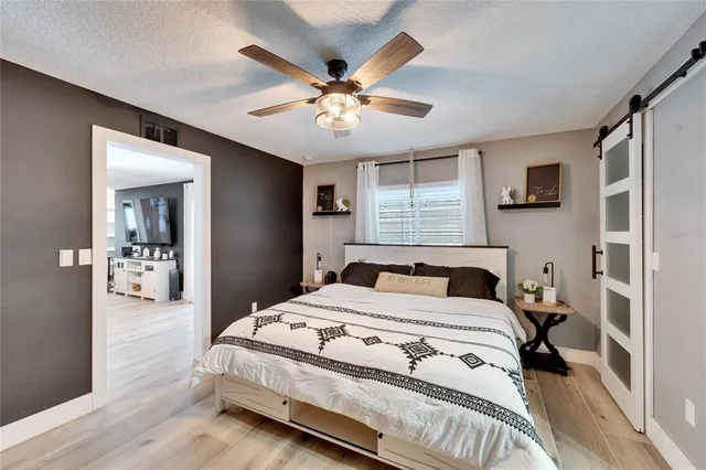 a bedroom with a bed and a chandelier