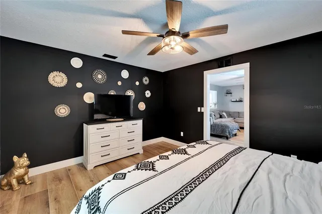 a bedroom with a bed and a chandelier