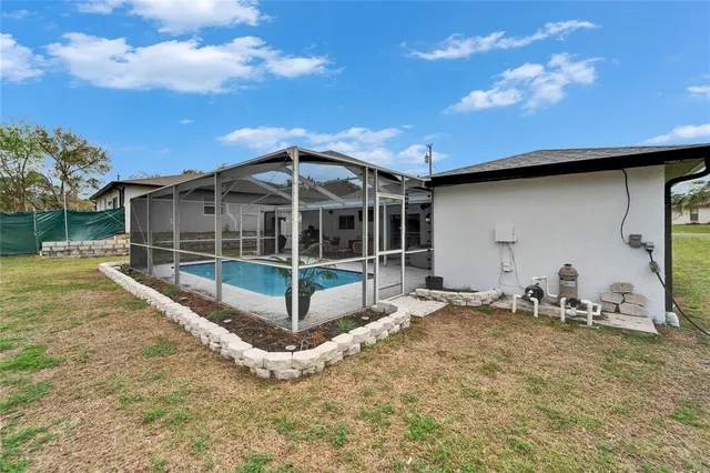 a house with swimming pool in front of it