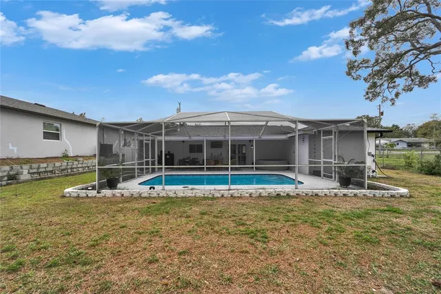 a view of a house with a backyard and a patio