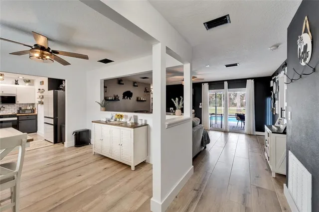 a kitchen with stainless steel appliances kitchen island wooden floors stove and cabinets