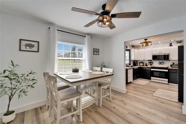 a view of a dining room with furniture and a kitchen