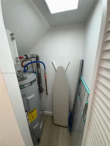 a view of walk in closet with clothes and water camper